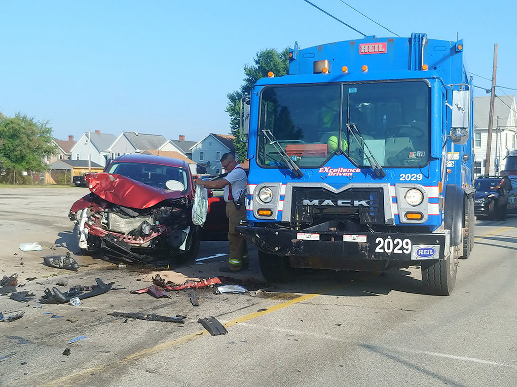 Vehicle, garbage truck collide